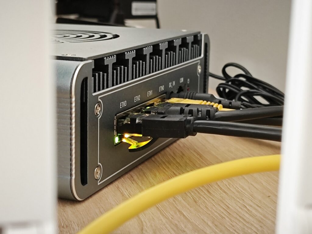 Photo of the back panel of the home server with some ethernet cables attached